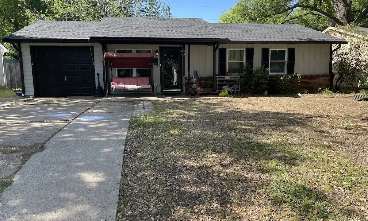 Wind Damage Roof Repair crew at work on a residential roof in Raleigh